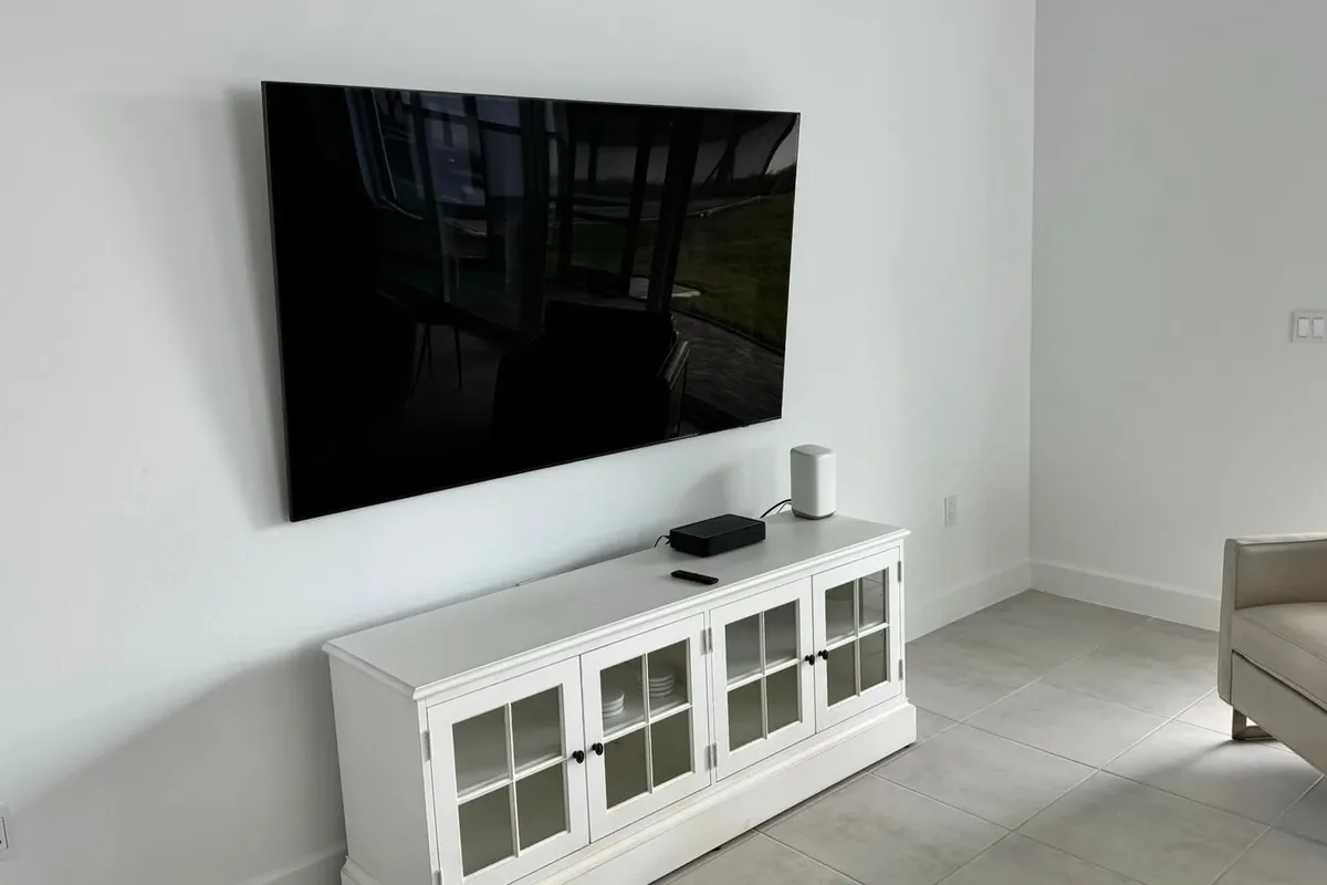 Wireless TV mounting with LG OLED TV and Xfinity modem in Naples