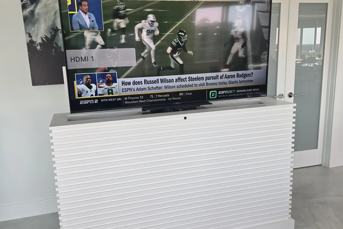 Custom lift cabinet TV installation with hidden wiring and motorized lift