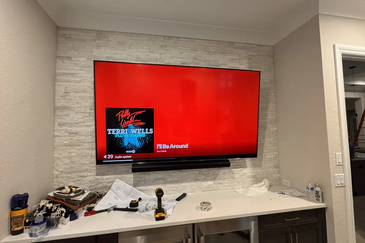 Living room with mounted TV on stone accent wall