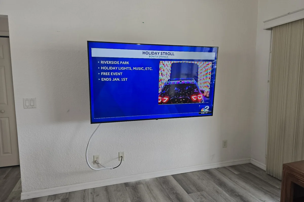 Wall-mounted TV displaying local Holiday Stroll event in Bonita Springs